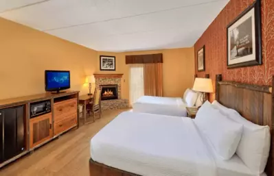 2 beds in a room with a fireplace