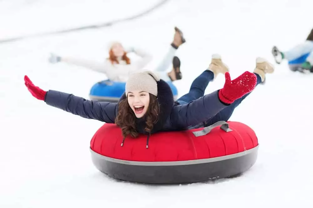 Happy girl snowtubing