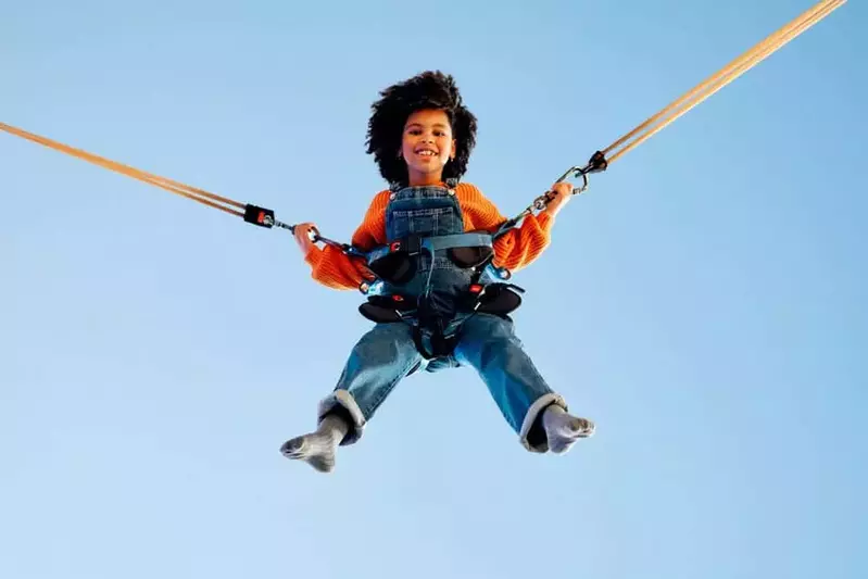 An,African,American,Girl,Child,With,Afro,Curly,Hair,Jumping
