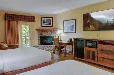 hotel room with fireplace and balcony